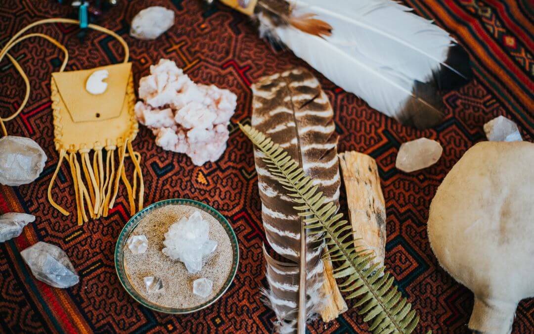 Spiritual altar with feathers, leaves and crystals